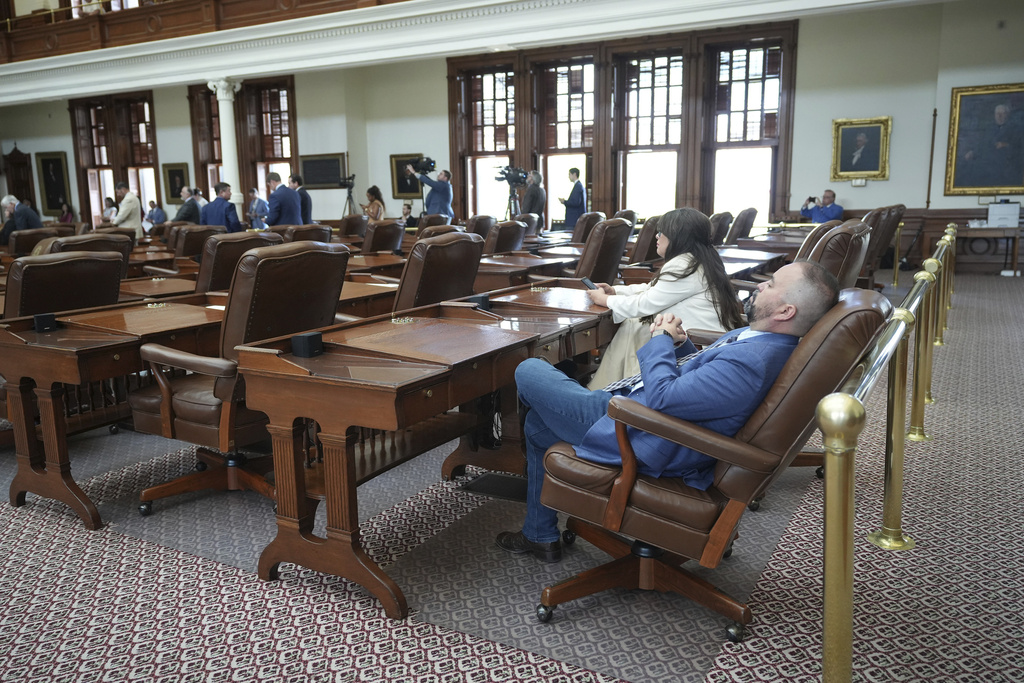 Rep. Joe Moody, D-El Paso, right, and Rep. Mary Gonzalez, D-Clint, take their seats in the House Chamber at the Capitol in Austin, Texas, Monday, Aug. 11, 2025. (Jay Janner/Austin American-Statesman via AP)