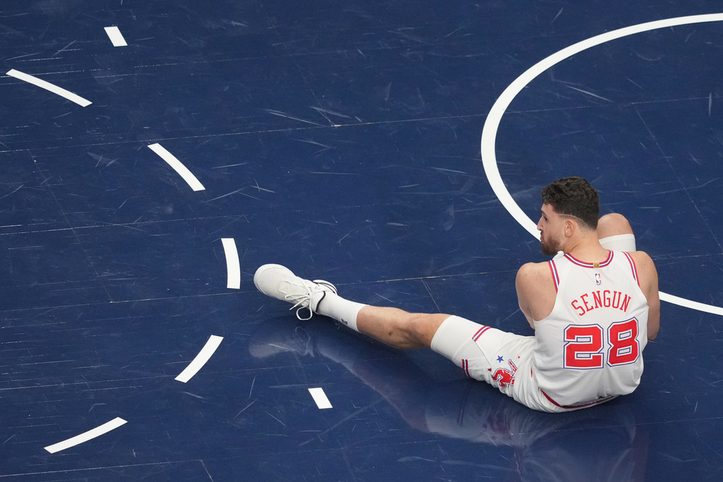 Houston Rockets center Alperen Sengun rests on the floor after falling on a play against the Dallas Mavericks during the first half of an NBA basketball game Saturday, Jan. 3, 2026, in Dallas. (AP Photo/Julio Cortez)