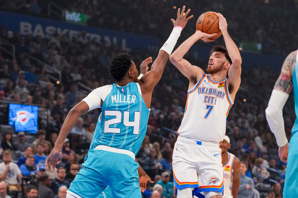 Oklahoma City Thunder center Chet Holmgren (7) looks to shoot over Charlotte Hornets forward Brandon Miller (24) during the first half of an NBA basketball game, Monday, Jan. 5, 2026, in Oklahoma City. (AP Photo/Kyle Phillips)