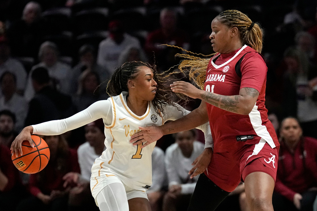 Vanderbilt's Mikayla Blakes (1) drives against Alabama's Essence Cody (21) in the first half of an NCAA college basketball game Thursday, Feb. 26, 2026, in Nashville, Tenn. (AP Photo/Mark Humphrey)