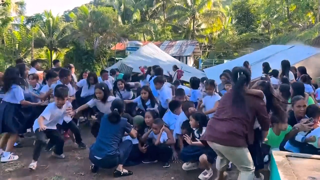 This image made from video provided by DepEd Mahayahay Elementary School shows school children reacting as a canopy roof, rear, collapsed, caused by a powerful earthquake Monday, June 8, 2026, in Malita, Davao Occidental Province, Philippines. (DepEd Mahayahay Elementary School via AP)