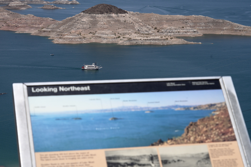 A paddle boat goes past a once nearly submerged island in Lake Mead near Boulder City, Nev., on Friday, Aug. 7, 2026. (AP Photo/Ty ONeil)