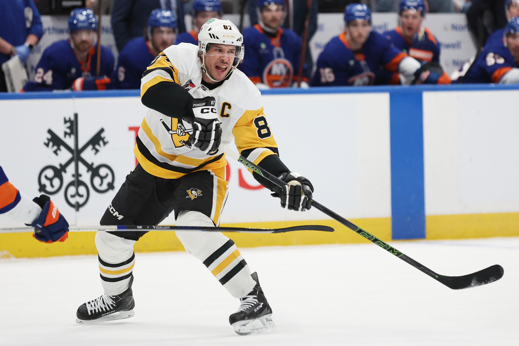 Pittsburgh Penguins center Sidney Crosby passes the puck during the first period of an NHL hockey game against the New York Islanders, Tuesday, Feb. 3, 2026, in Elmont, N.Y. (AP Photo/Heather Khalifa)