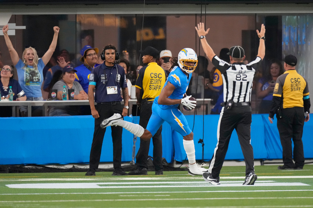 Los Angeles Chargers wide receiver Quentin Johnston, center, celebrates after scoring a touchdown during the first half of an NFL preseason football game against the Los Angeles Rams Thursday, Aug. 27, 2026, in Inglewood, Calif. (AP Photo/Mark J. Terrill)