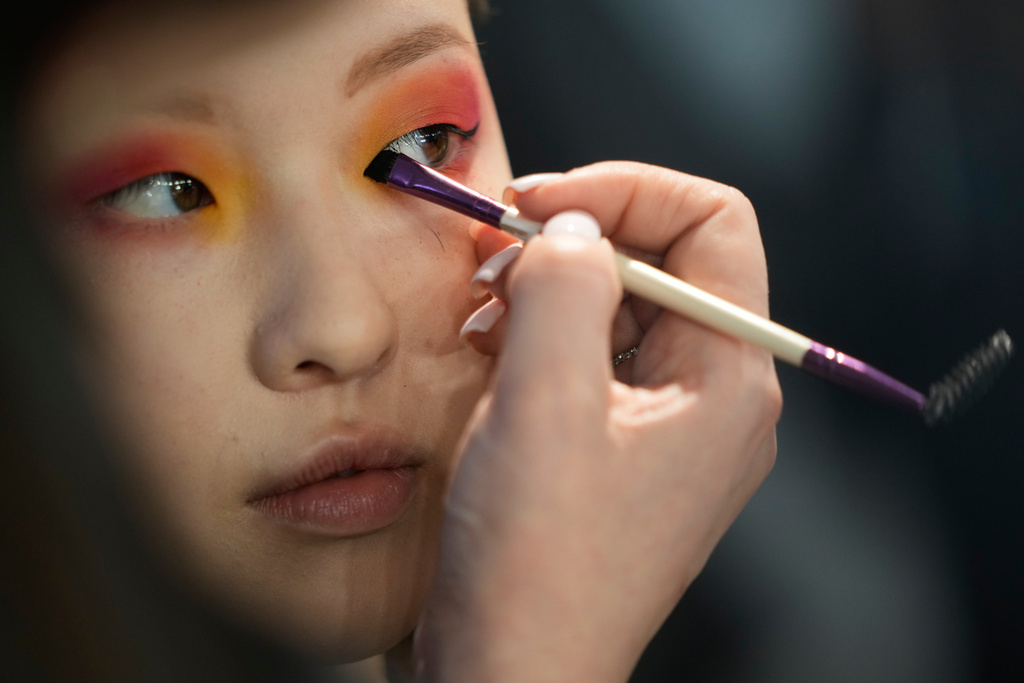 A model gets ready for a runway show at the backstage of the Moscow Fashion Week in Moscow, Saturday, March 14, 2026. (AP Photo/Pavel Bednyakov)