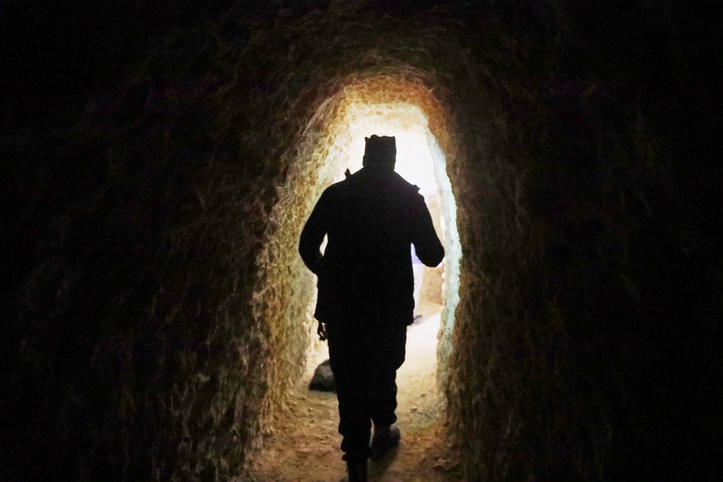 A member of Syrian security forces inspects a tunnel in the predominantly Kurdish Sheikh Maqsoud neighborhood, where clashes broke out Tuesday, Jan. 6, between government forces and the Kurdish-led Syrian Democratic Forces in the northern city of Aleppo, Syria, Monday, Jan. 12, 2026. (AP Photo/Omar Albam)