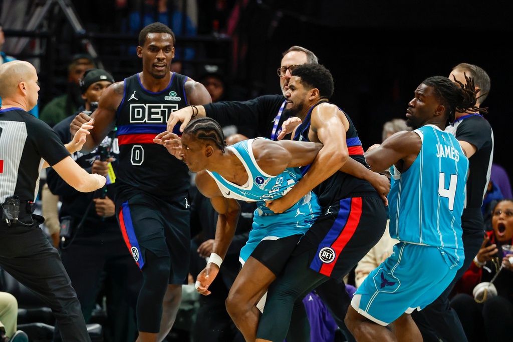 Charlotte Hornets forward Moussa Diabate, second from left, is held back as he goes after Detroit Pistons center Jalen Duren during a fight on the court in the second half of an NBA basketball game in Charlotte, N.C., Monday, Feb. 9, 2026. (AP Photo/Nell Redmond)