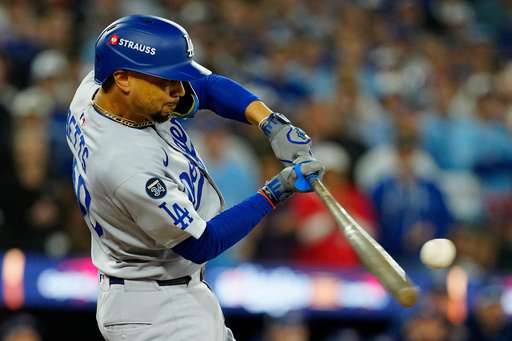 Los Angeles Dodgers' Mookie Betts (50) hits a two-run single against the Toronto Blue Jays during the third inning in Game 6 of baseball's World Series in Toronto on Friday, Oct. 31, 2025. (Frank Gunn/The Canadian Press via AP) Los Angeles Dodgers' Mookie Betts (50) hits a two-run single against the Toronto Blue Jays during the third inning in Game 6 of baseball's World Series in Toronto on Friday, Oct. 31, 2025. (Frank Gunn/The Canadian Press via AP)