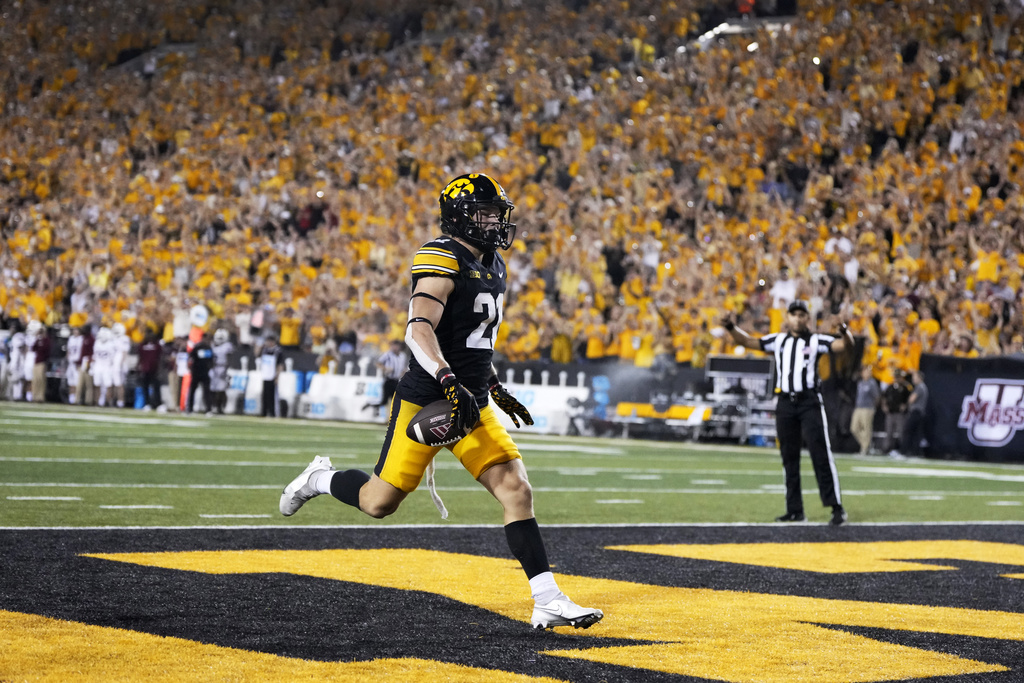 Iowa's Kaden Wetjen (21) celebrates as he returns a punt for a touchdown during the second half of an NCAA college football game against Massachusetts, Saturday, Sept. 13, 2025, in Iowa City, Iowa. (AP Photo/Charlie Neibergall)