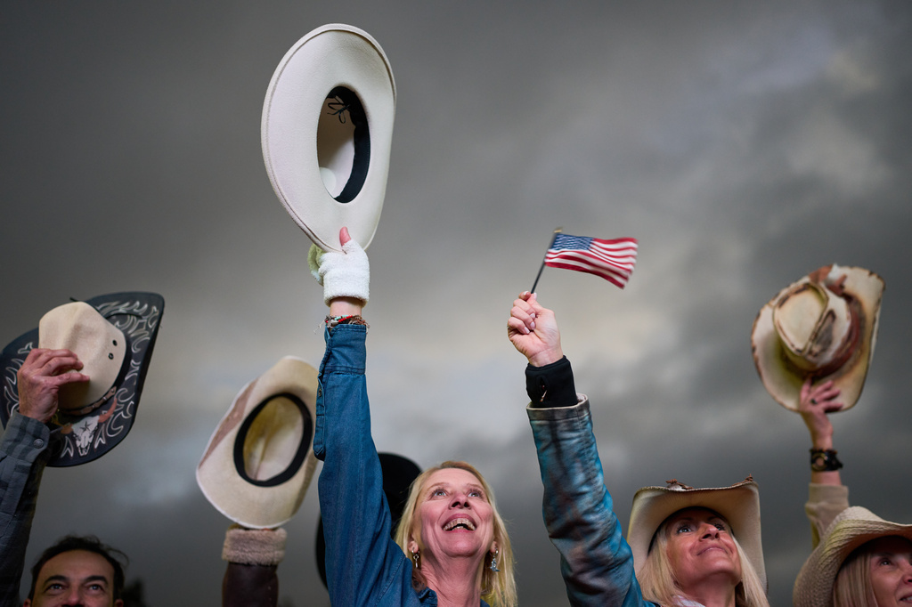 People raise their hats while dancing during celebrations marking the 250th anniversary of U.S. independence in Buenos Aires, Argentina, Saturday, July 4, 2026.(AP Photo/Rodrigo Abd)