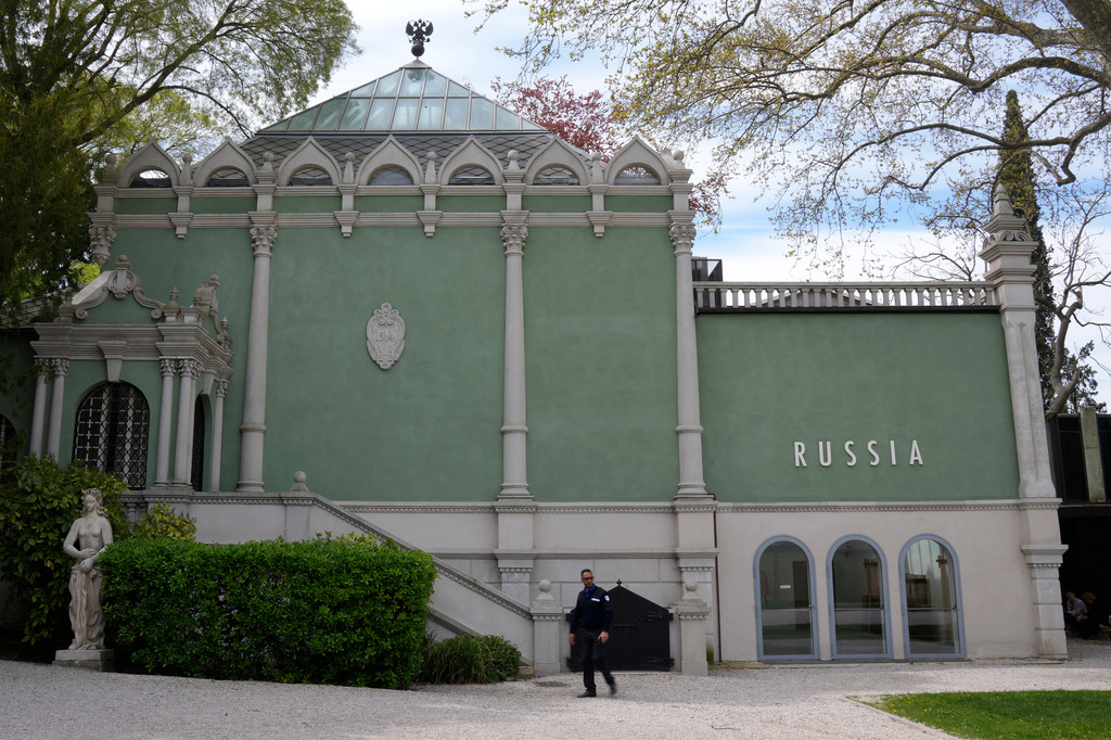 FILE - A private security officer walks past next to a closed Russia's pavilion at the 59th Biennale of Arts exhibition in Venice, Italy, Tuesday, April 19, 2022. (AP Photo/Antonio Calanni, File)