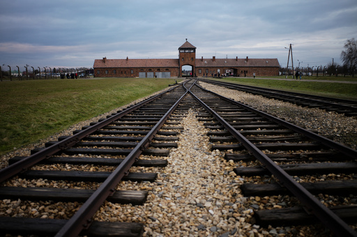 FILE - The railway tracks where hundred thousands of people arrived to be directed to the gas chambers inside the former Nazi death camp of Auschwitz Birkenau, or Auschwitz II, are pictured in Oswiecim, Poland, on Dec. 7, 2019. (AP Photo/Markus Schreiber, File) FILE - The railway tracks where hundred thousands of people arrived to be directed to the gas chambers inside the former Nazi death camp of Auschwitz Birkenau, or Auschwitz II, are pictured in Oswiecim, Poland, on Dec. 7, 2019. (AP Photo/Markus Schreiber, File)