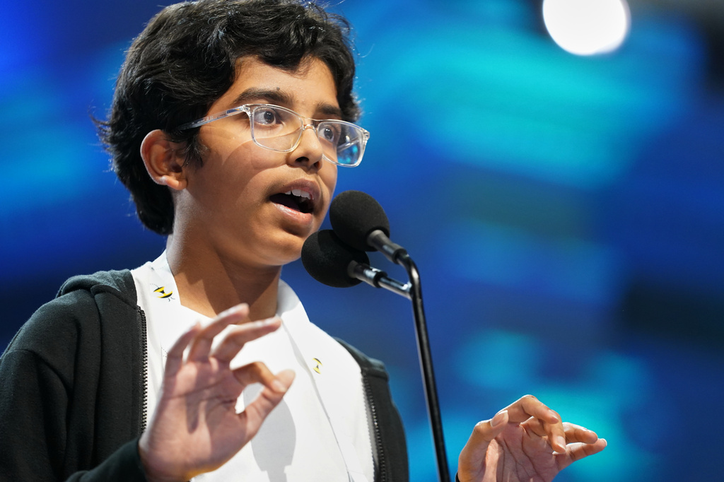 Sarv Dharavane, 12, Dunwoody, Ga., spells his word during the final round of the 2026 Scripps National Spelling Bee in Washington, Thursday, May 28, 2026. (AP Photo/Allison Robbert)