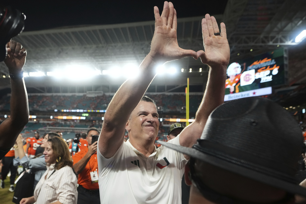 Miami head coach Mario Cristobal celebrates after Miami defeated Notre Dame in an NCAA college football game, Sunday, Aug. 31, 2025, in Miami Gardens, Fla. (AP Photo/Lynne Sladky)