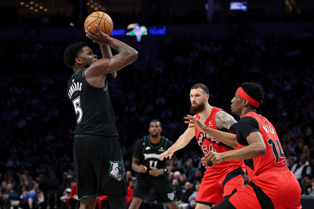 Minnesota Timberwolves guard Anthony Edwards, left, shoots over Toronto Raptors guard Ja'kobe Walter, right, during the second half of an NBA basketball game, Thursday, March 5, 2026, in Minneapolis. (AP Photo/Matt Krohn)