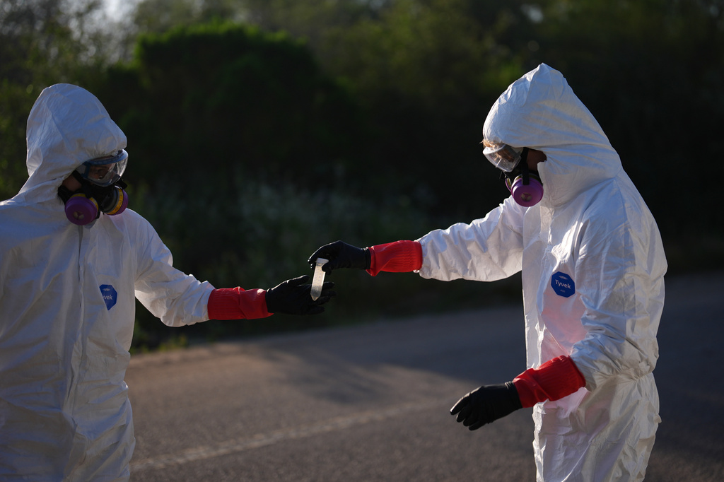 Trent Fry, right, and Leila El Masri handle a water sample of the Tijuana River, as part of a research team from the University of California, San Diego, Wednesday, March 11, 2026, in San Diego. (AP Photo/Gregory Bull)
