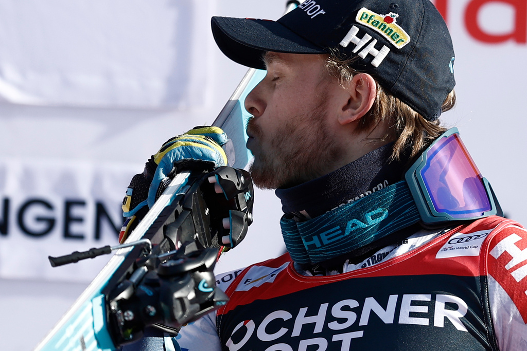 Norway's Atle Lie McGrath kisses his skis as he celebrates on the podium after winning an alpine ski, men's World Cup slalom, in Wengen, Switzerland, Sunday, Jan. 18, 2026. (AP Photo/Gabriele Facciotti)