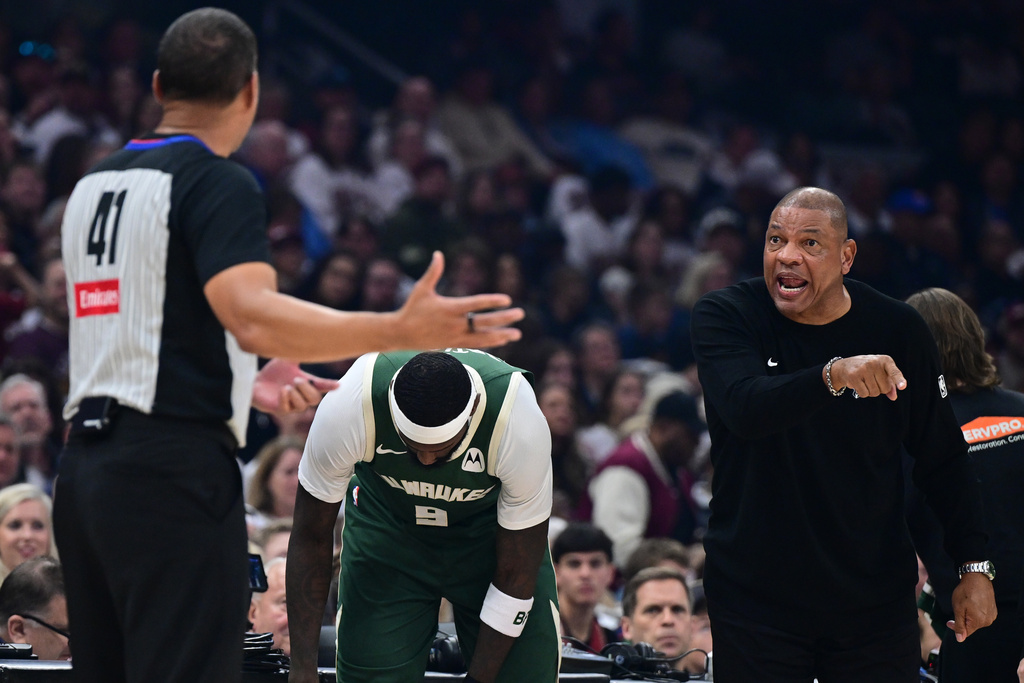 Milwaukee Bucks head coach Doc Rivers, right, disputes a call with referee Nate Green, left, in the first half of an NBA basketball game against the Cleveland Cavaliers, Sunday, Oct. 26, 2025, in Cleveland. (AP Photo/David Dermer)