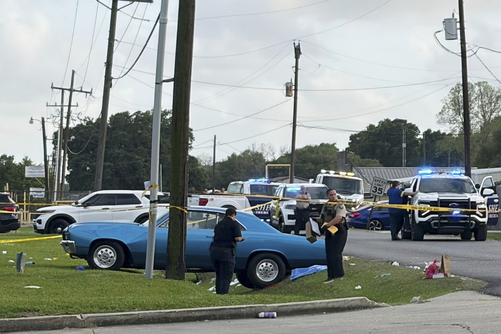 Police work the scene after several people were injured when a vehicle struck revelers at a parade celebrating the Lao New Year on Saturday, April 4, 2026, in Broussard, La. (WBRZ via AP)