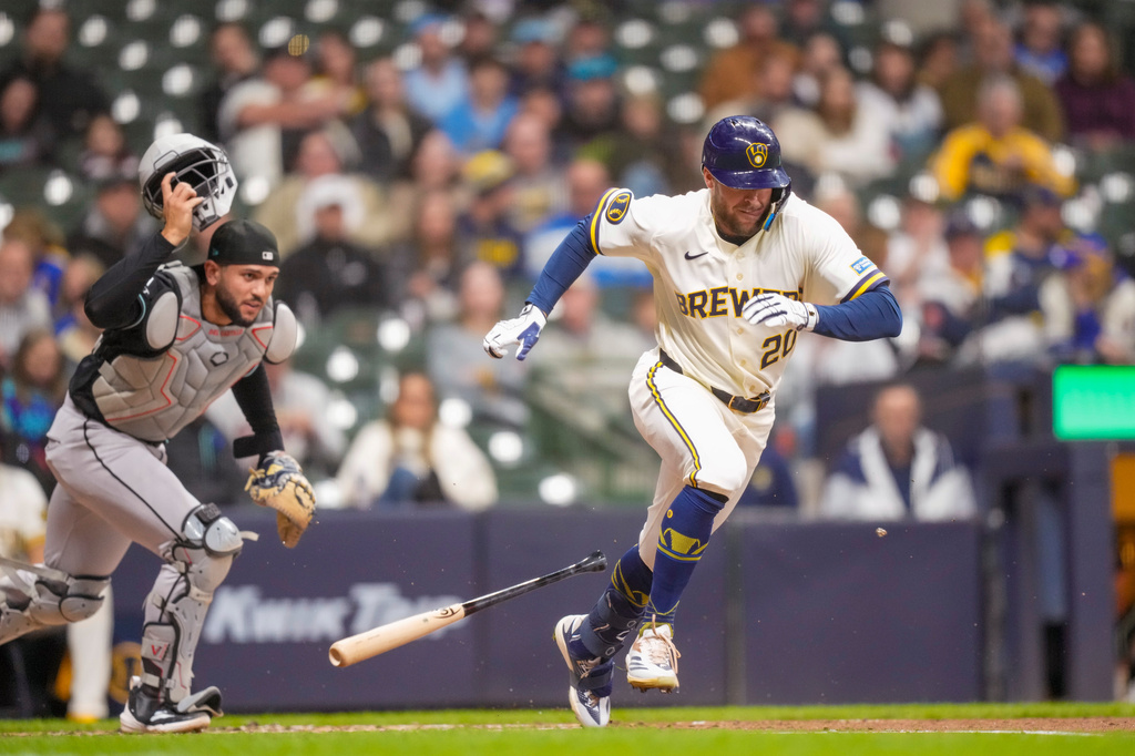 Milwaukee Brewers' Brandon Lockridge (20) bunts a single against Arizona Diamondbacks catcher Adrian del Castillo during the third inning of a baseball game Wednesday, April 29, 2026, in Milwaukee. (AP Photo/Andy Manis)