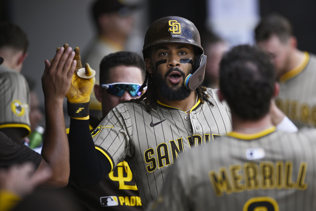 San Diego Padres' Fernando Tatis Jr. celebrates with teammates in the dugout after hitting a solo home run during the third inning of a baseball game against the Chicago White Sox, Sunday, Sept. 21, 2025, in Chicago. (AP Photo/Paul Beaty)