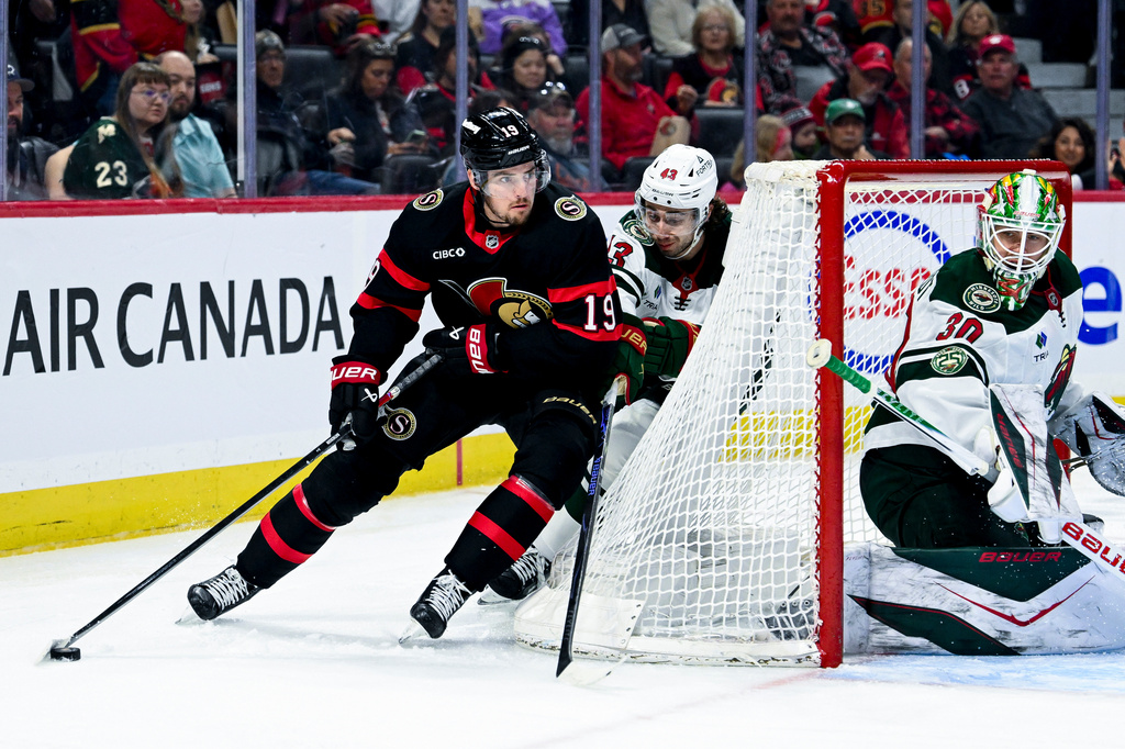 Ottawa Senators' Drake Batherson (19) is chased down by Minnesota Wild's Quinn Hughes (43) during the second period of an NHL hockey game, Saturday, April 4, 2026, in Ottawa, Ontario. (Spencer Colby/The Canadian Press via AP)