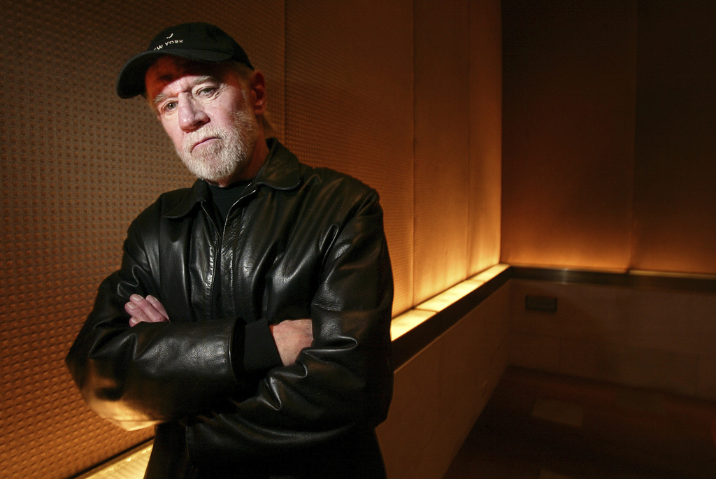 FILE - Actor and comedian George Carlin poses in a New York hotel March 19, 2004. (AP Photo/Gregory Bull, File)