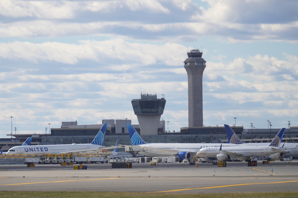 Planes are seen in front of an air traffic control tower at Newark International Airport in Newark, N.J., Thursday, Nov. 6, 2025. (AP Photo/Seth Wenig)