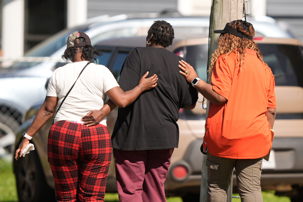 People are consoled outside the scene of a mass shooting, Sunday, April 19, 2026, in Shreveport, La. (AP Photo/Gerald Herbert)