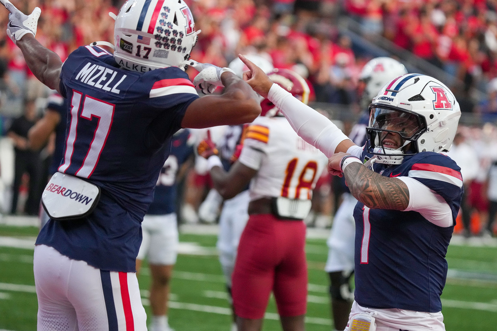 Arizona's Isaiah Mizell (17) celebrates with quarterback Noah Fifita (1) after scoring a touchdown against Iowa State during the first half of an NCAA college football game Saturday, Oct. 24, 2026, in Tucson, Ariz. (AP Photo/Darryl Webb)