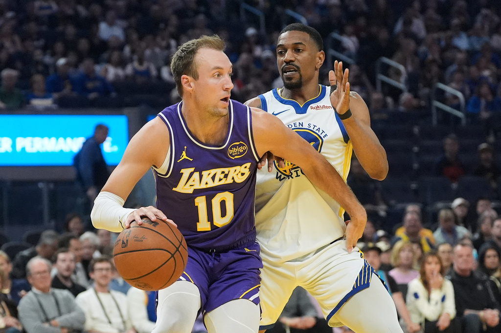 Los Angeles Lakers guard Luke Kennard (10) drives to the basket against Golden State Warriors guard De'Anthony Melton during the first half of an NBA basketball game in San Francisco, Thursday, April 9, 2026. (AP Photo/Jeff Chiu)