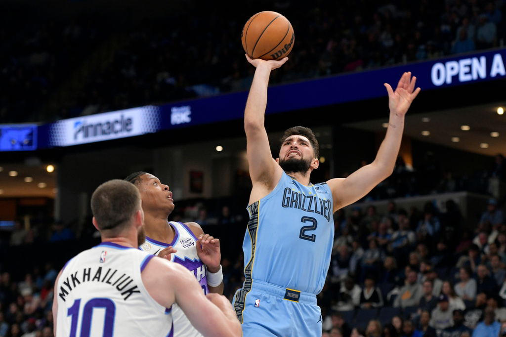 Memphis Grizzlies guard Ty Jerome (2) shoots against Utah Jazz forward Ace Bailey, center, and guard Svi Mykhailiuk (10) in the second half of an NBA basketball game Wednesday, Oct. 21, 2026, in Memphis, Tenn. (AP Photo/Brandon Dill)
