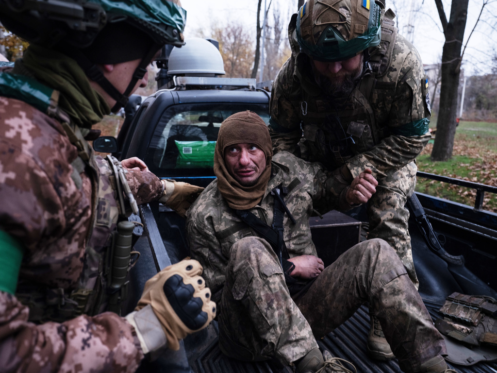 In this photo provided by Ukraine's 93rd Kholodnyi Yar Separate Mechanized Brigade press service, servicemen evacuate their wounded fellow soldier Oleg Solonchak near Kostyantynivka, Donetsk region, Ukraine, Tuesday, Nov. 11, 2025. (Iryna Rybakova/Ukraine's 93rd Mechanized Brigade via AP)