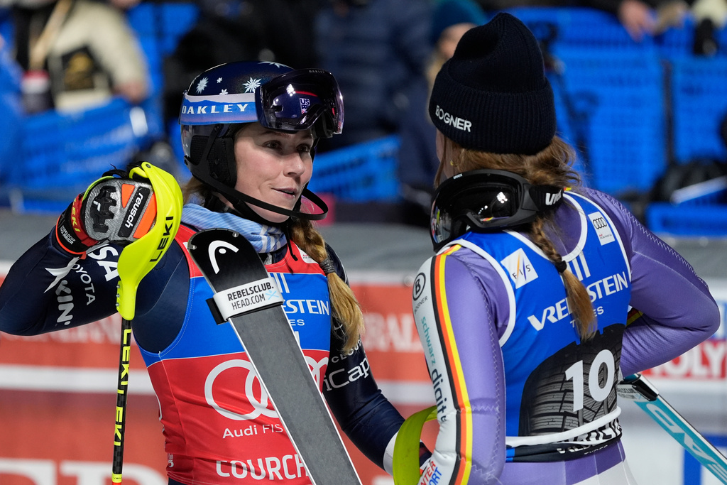 United States' Mikaela Shiffrin, left, winner of an alpine ski, women's World Cup slalom, and Germany's Emma Aicher, third-placed, congratulate each other at the finish area, in Courchevel, France, Tuesday, Dec. 16, 2025. (AP Photo/Giovanni Auletta)