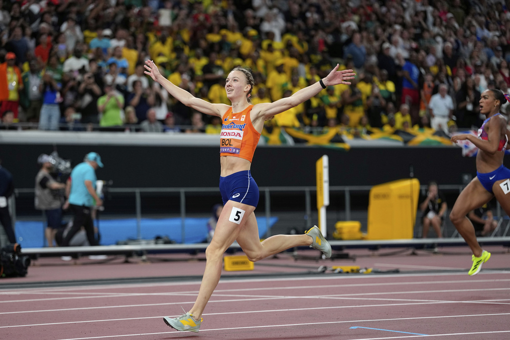 Netherlands' Femke Bol crosses the finish line ahead of United States' Jasmine Jones to win the women's 400 meters hurdles final at the World Athletics Championships in Tokyo, Friday, Sept. 19, 2025. (AP Photo/Matthias Schrader)