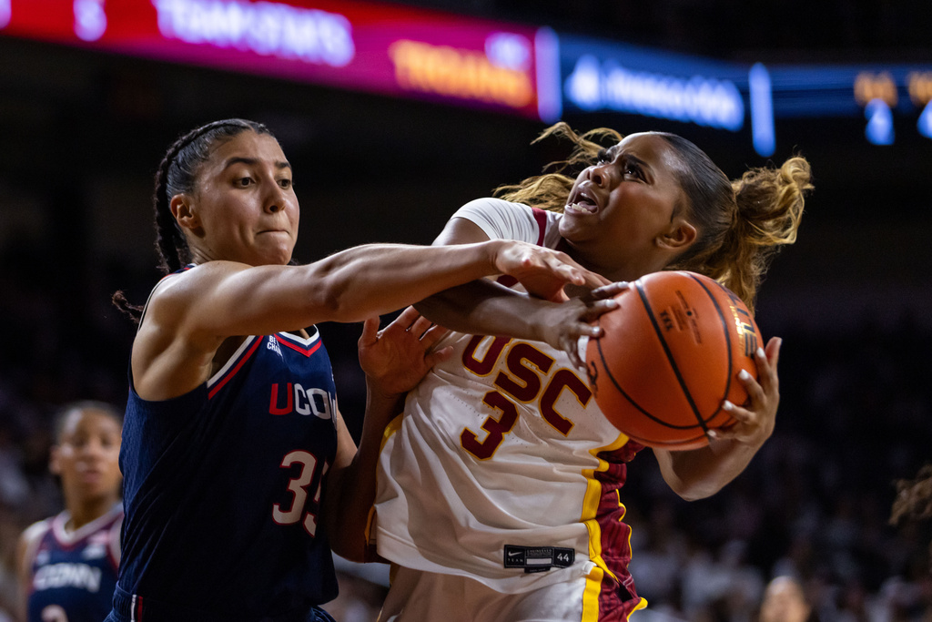 Southern California guard Londynn Jones (3) is defended by UConn guard Azzi Fudd (35) during the first half of an NCAA college basketball game Saturday, Dec. 13, 2025, in Los Angeles. (AP Photo/Ethan Swope)