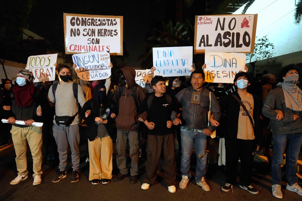 Opponents of Peruvian President Dina Boluarte protest outside of the Ecuadorian Embassy in Lima, Peru, Thursday, Oct. 9, 2025. (AP Photo/Martin Mejia)