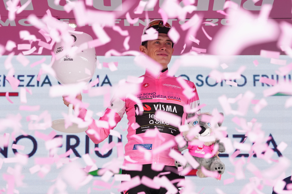 Denmark's Jonas Vingegaard wears the pink jersey of the race overall leader following stage 17 of the Giro d'Italia cycling race from Cassano D'Adda to Andalo, Italy, Wednesday, May 27, 2026. (Gianmattia D'Albertoi/LaPresse via AP) CORRECTION: race title corrected to overall leader only instead of him winning 17th stage