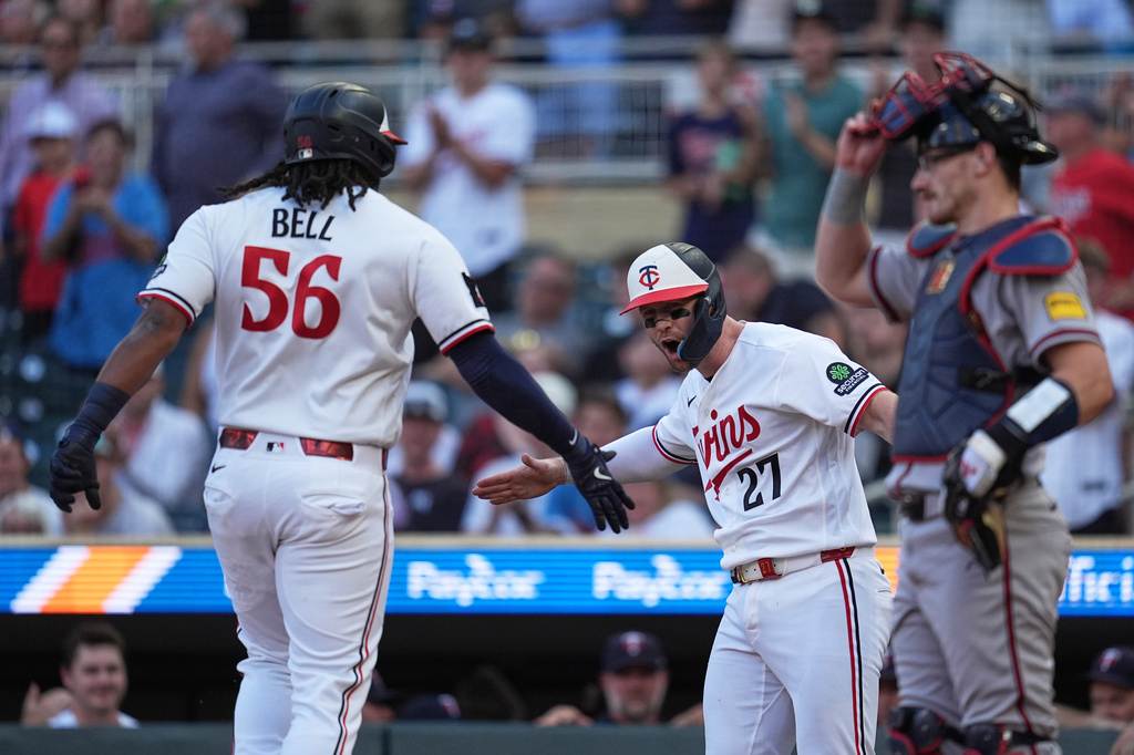 Minnesota Twins' Josh Bell (56) is greeted by Ryan Jeffers (27) while crossing home plate after hitting a 2-run home run during the first inning of a baseball game against the Atlanta Braves in Minneapolis, Tuesday, Aug. 18, 2026. (AP Photo/Abbie Parr)