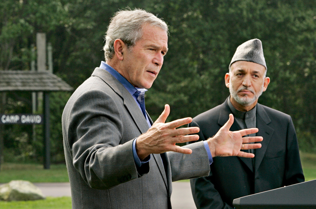 FILE - President George W. Bush, left, accompanied by Afghanistan's President Hamid Karzai, right, gestures during their joint press conference, Monday, Aug. 6, 2007, at Camp David, Md. (AP Photo/J. Scott Applewhite, File)