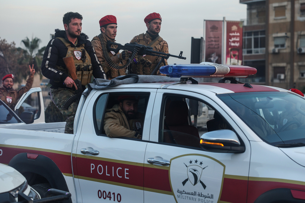 Syrian government soldiers ride a vehicle during clashes with Kurdish fighters in a contested area of the northern city of Aleppo, Syria, Wednesday, Jan. 7, 2026. (AP Photo/Ghaith Alsayed)