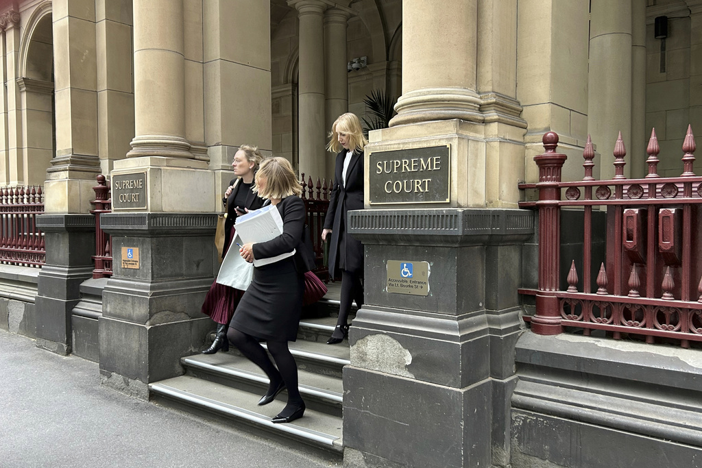 People leave the Supreme Court of Victoria in Melbourne, on Friday, Aug. 15, 2025. (AP Photo/Rod McGuirk)