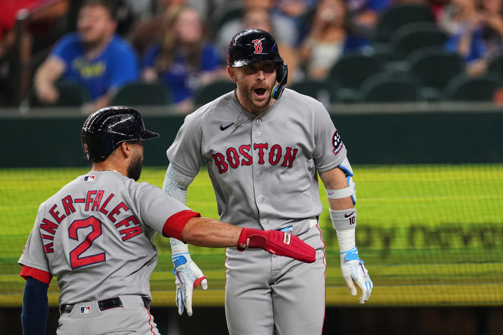Boston Red Sox's Isiah Kiner-Falefa (2) and Trevor Story, right, celebrate Story's three-run home run in the eighth inning of a baseball game against the Texas Rangers Thursday, Sept. 17, 2026, in Arlington, Texas (AP Photo/Tony Gutierrez)