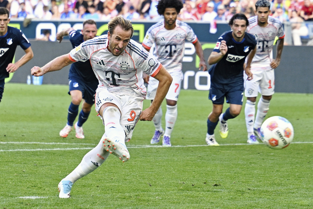Bayern's Harry Kane scores their side's third goal of the game from a penalty during the German Bundesliga soccer match between Hoffenheim and Bayern Munich at the PreZero Arena in Sinsheim, Germany, Saturday Sept. 20, 2025. (Uwe Anspach/dpa via AP)
