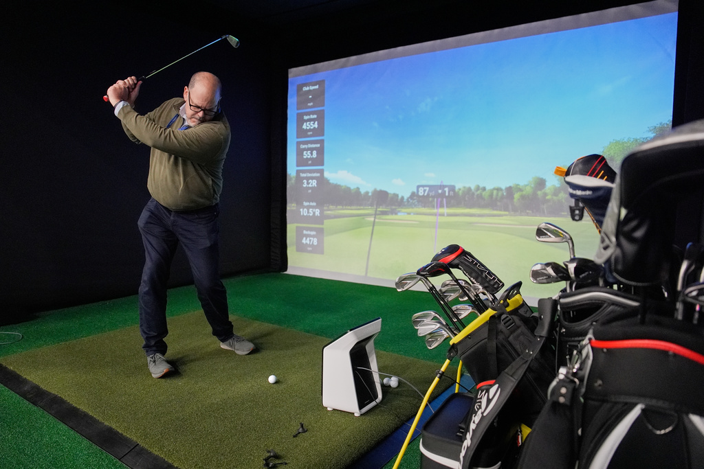 A man tries out the Garmin Approach R50 golf monitor and simulator during the CES tech show Tuesday, Jan. 6, 2026, in Las Vegas. (AP Photo/John Locher)
