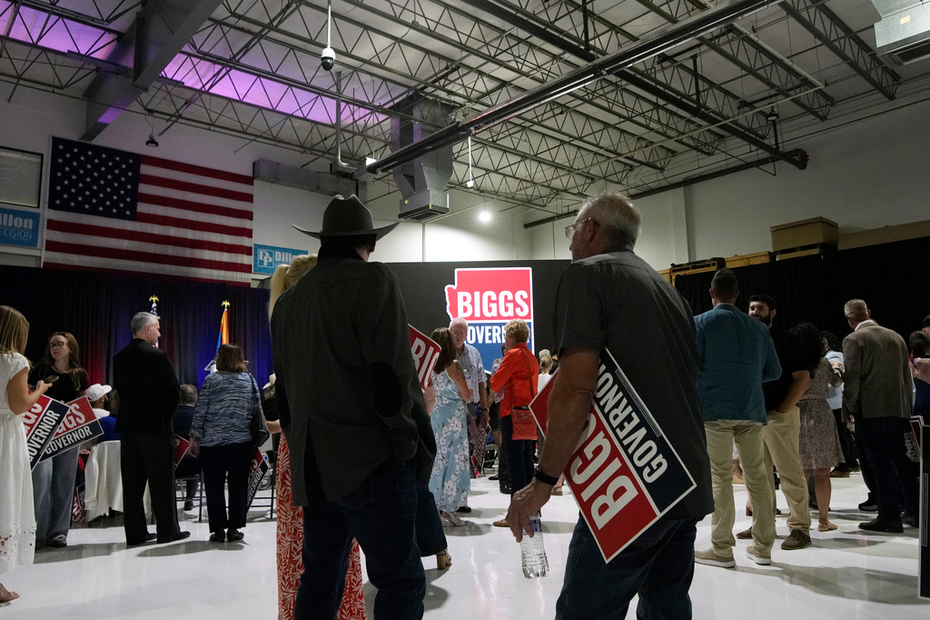 Attendees stand at a primary election night watch party for Republican gubernatorial candidate U.S. Rep. Andy Biggs on Tuesday, July 21, 2026, in Scottsdale, Ariz. (AP Photo/Ross D. Franklin)