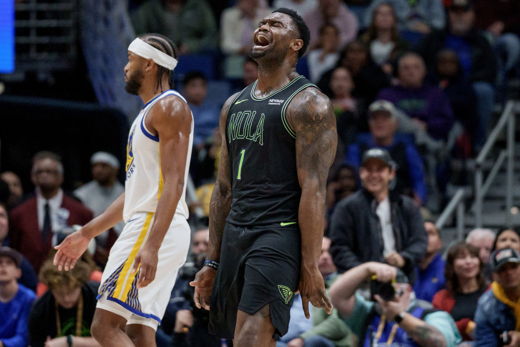 New Orleans Pelicans forward Zion Williamson (1) reacts next to Golden State Warriors guard Moses Moody during the first half of an NBA basketball game in New Orleans, Tuesday, Feb. 24, 2026. (AP Photo/Matthew Hinton)