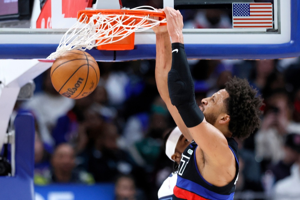 Detroit Pistons guard Cade Cunningham (2) dunks the ball against the Memphis Grizzlies during the first half of an NBA basketball game Friday, March 13, 2026, in Detroit. (AP Photo/Duane Burleson)