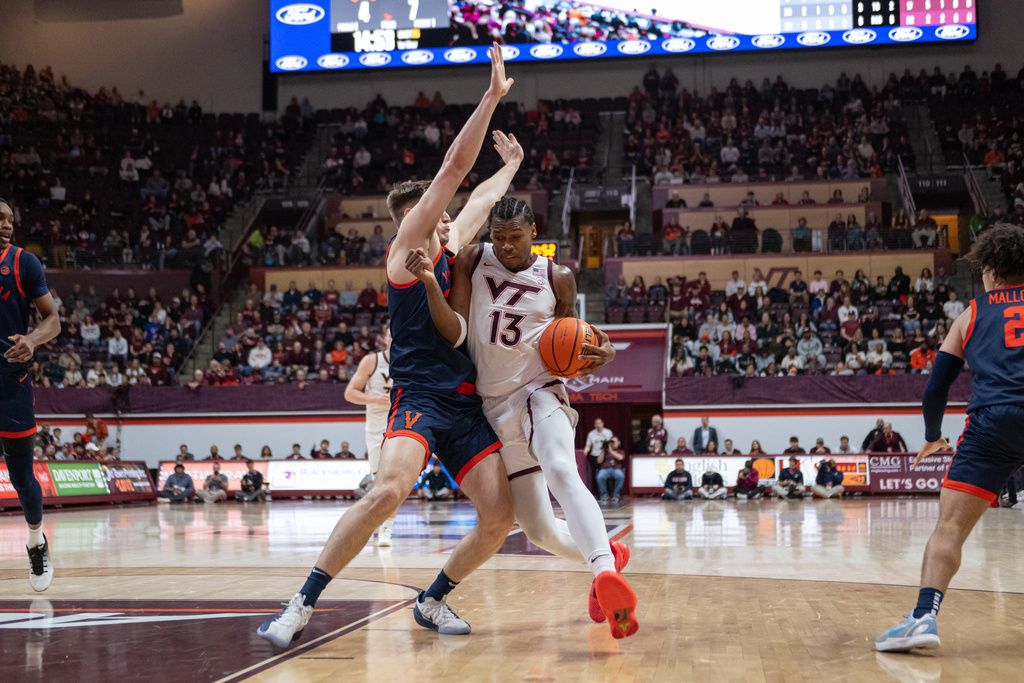 Virginia Tech forward Amani Hansberry (13) drives to the basket against Virginia during the first half of an NCAA college basketball game, Wednesday, Dec. 31, 2025, in Blacksburg, Va. (AP Photo/Robert Simmons)