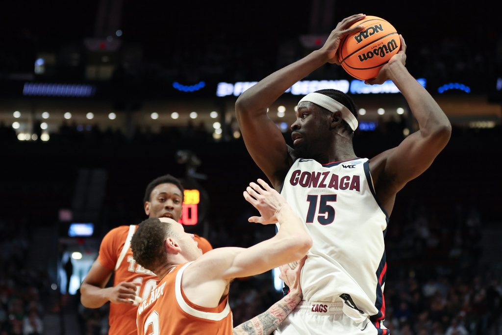 Gonzaga forward Graham Ike (15) looks to pass the ball around Texas guard Chendall Weaver (2) during the first half in the second round of the NCAA college basketball tournament Saturday, March 21, 2026, in Portland, Ore. (AP Photo/Amanda Loman)